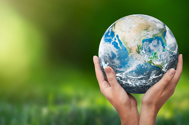 Two hands holding an earth